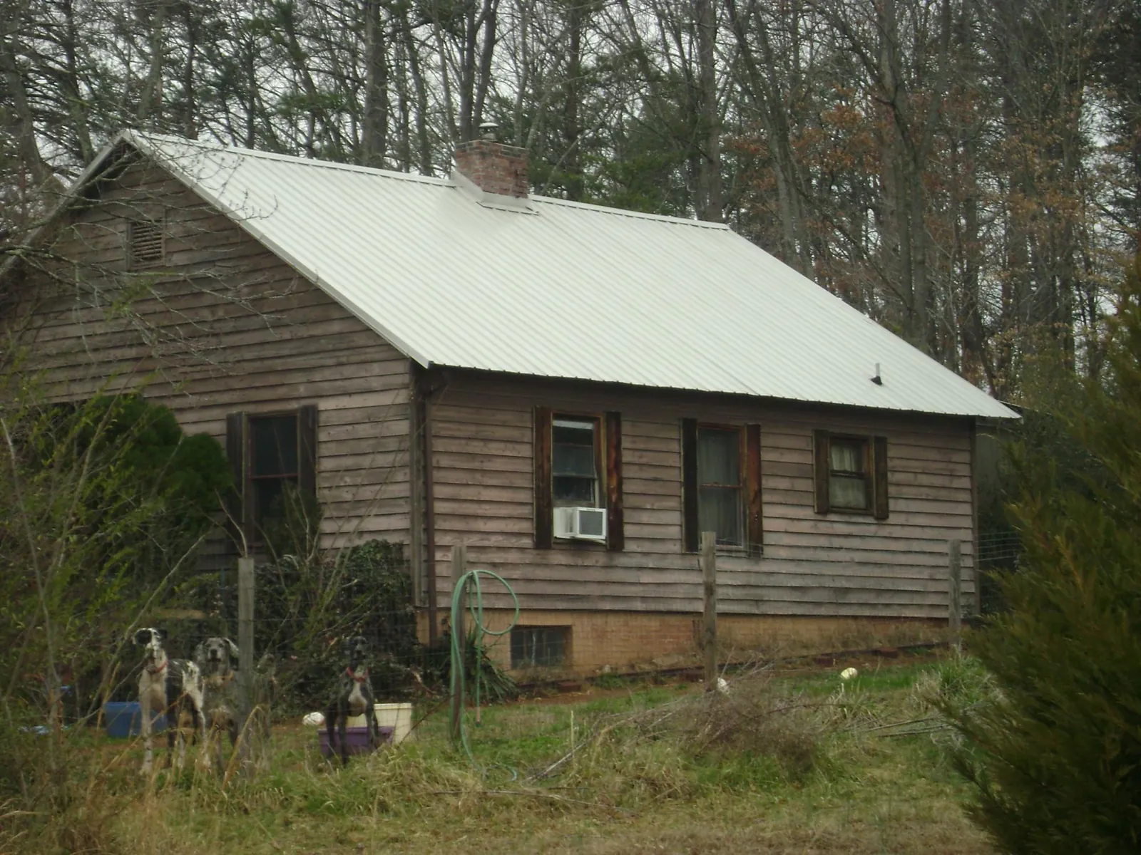 White metal roof on an old wood sided farmhouse, from a Metal Roof Installation job in Southmont